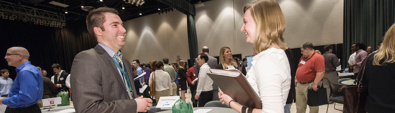 photo of a student and prospective employer at an event
