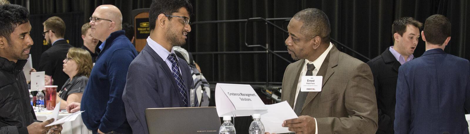 photo of a student talking to an employer at a mixer