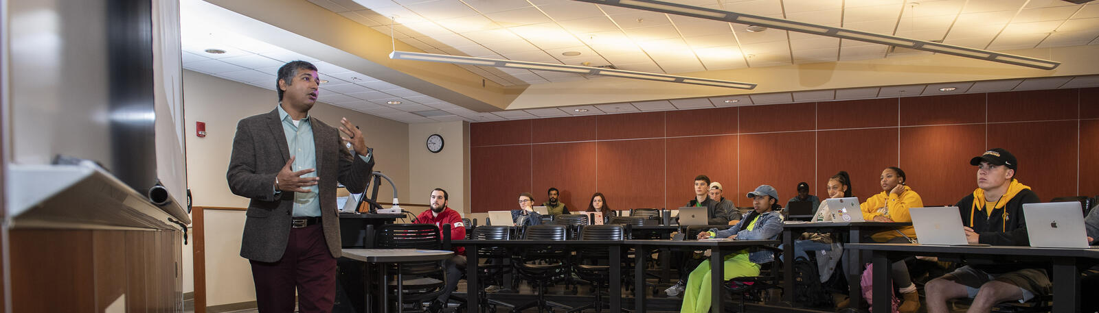photo of a professor and students in a classroom 