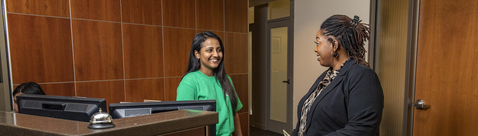 photo of a student and staff member talking