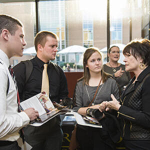photo of students talking to a board member